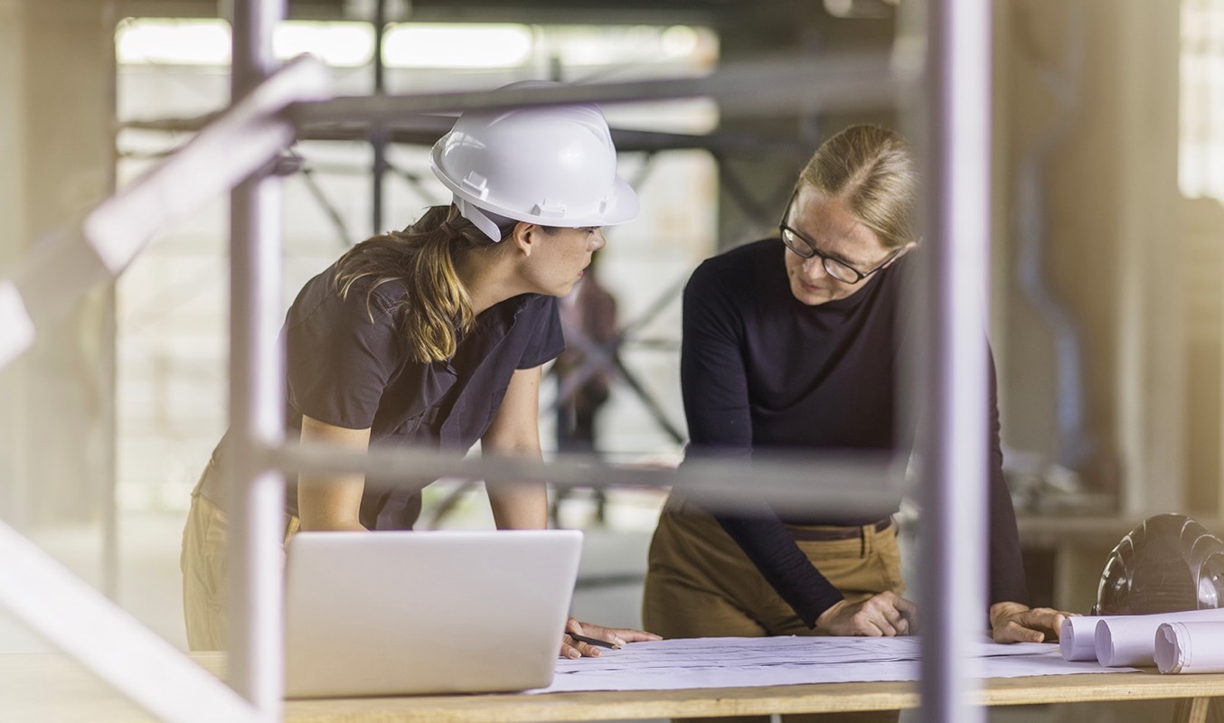Two women working through documents.