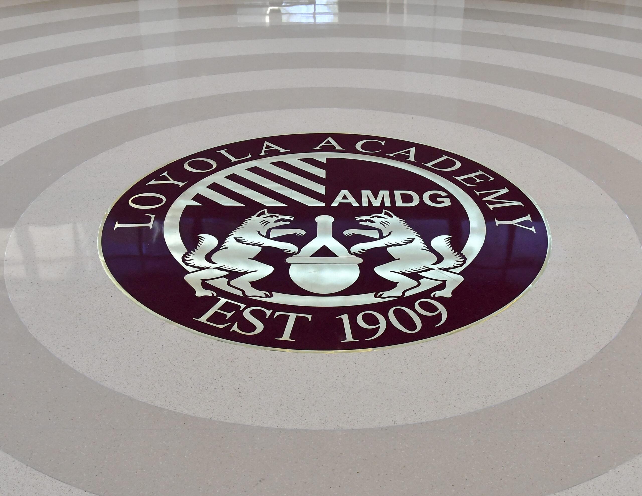 Signage and school emblem on floor, Loyola Academy Aquatic Center.