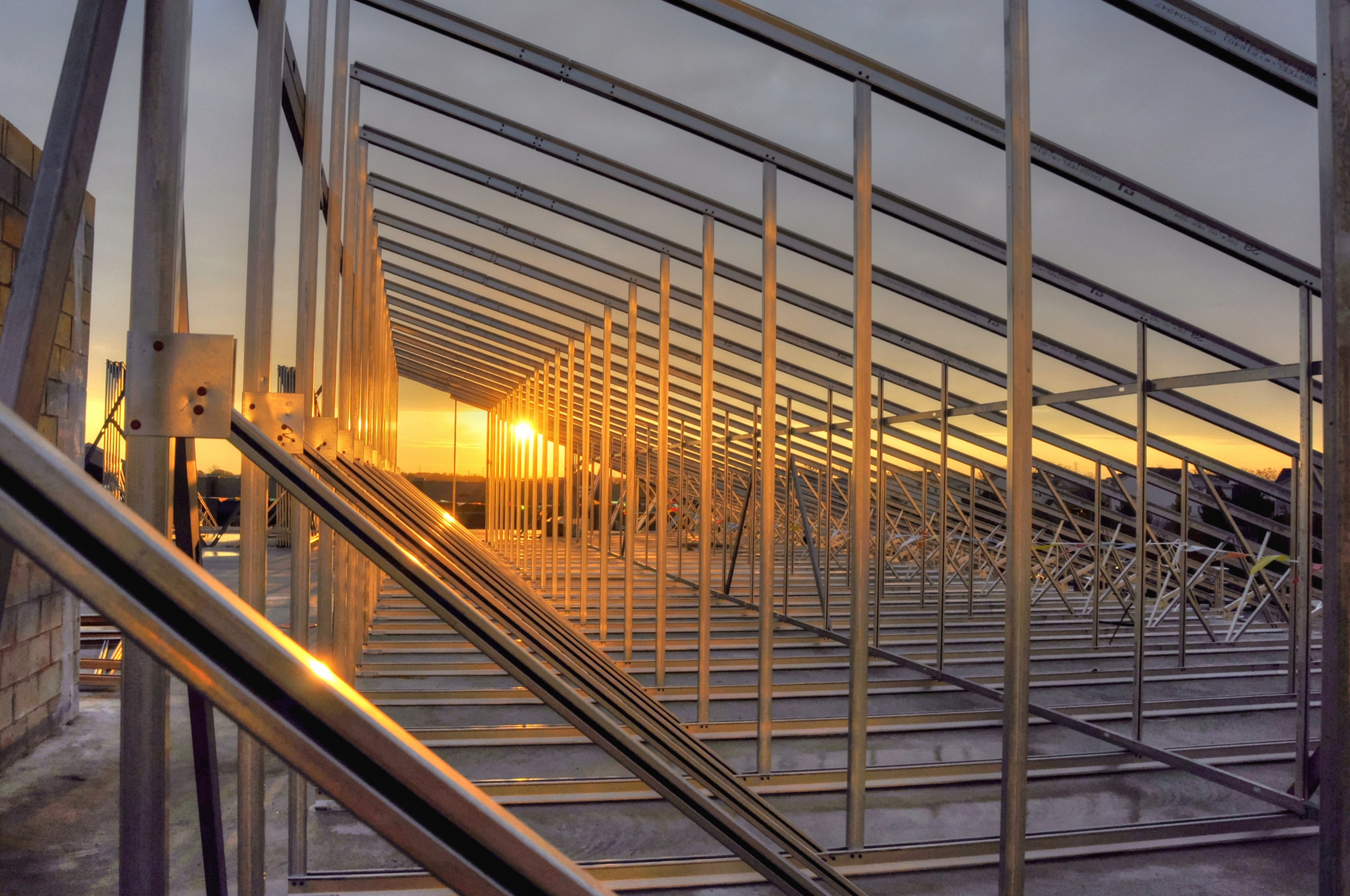 Construction photo of exposed structure and sunset.