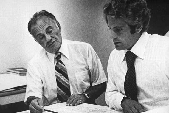 Historical photo of Valenti seniors, collaborating in office.